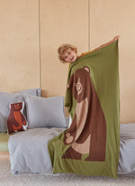 Kid smiling with large eco-friendly brown bear blanket
