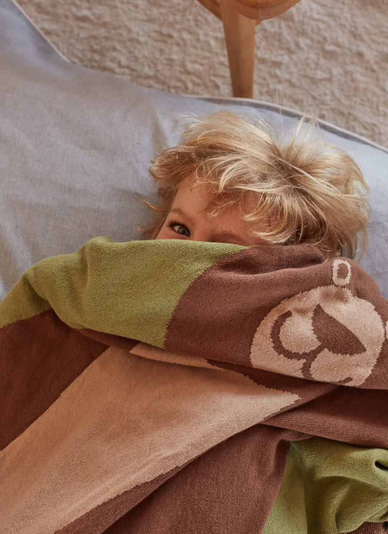 kid playing with large eco-friendly brown bear blanket